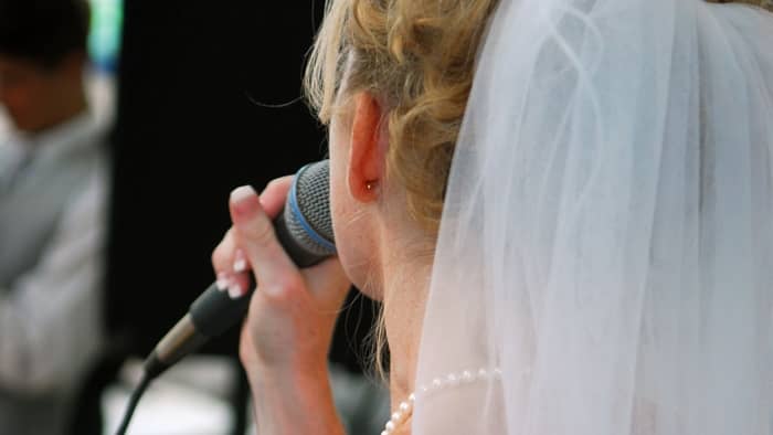 bride sings to groom at reception